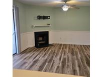 Living room showcasing modern vinyl floors, a charming fireplace and neutral paint at 2326 Treescape Dr # 2, Charleston, SC 29414