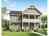 Charming two-story home featuring a covered front porch and a well-manicured lawn at 2950 Lodge Berry Ln, Johns Island, SC 29455
