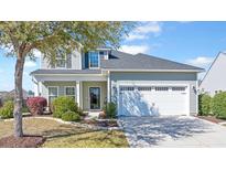 Charming two-story home with gray siding, a well-manicured lawn, and an attached two-car garage at 3016 Adventure Way, Ladson, SC 29456