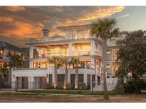 Stunning multi-story home featuring ample windows, multiple balconies, and palm tree landscaping at 3803 Palm Blvd, Isle of Palms, SC 29451