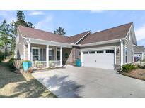 Charming home with a two-car garage, cozy front porch, beautiful stone accents, and well-manicured landscaping at 458 Four Seasons Blvd, Summerville, SC 29486