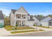 Charming two-story home with a welcoming front porch and well-maintained lawn at 68 Red Bluff St, Summerville, SC 29483