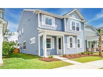 Charming two-story home with blue siding, white trim, and a well-manicured front yard at 131 Brant Dr, Summerville, SC 29483