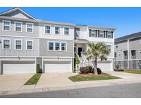 Attractive townhome with white siding, garage, and front stairs leading to the front door at 162 Winding River Dr, Johns Island, SC 29455