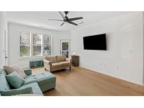 Bright living room featuring hardwood floors, a ceiling fan, and comfortable seating at 200 Bucksley Ln # 105, Charleston, SC 29492