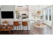 Modern kitchen with white cabinets, stainless steel appliances, and a breakfast bar with brown leather stools at 2022 Chatelain Way, Mount Pleasant, SC 29464
