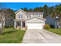 Charming two-story home with a well-manicured lawn and a spacious two-car garage at 206 Woodbrook Way, Moncks Corner, SC 29461