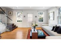 Bright living room featuring hardwood floors, contemporary furnishings, and natural light from large windows at 301 Broad St # 1, Charleston, SC 29401