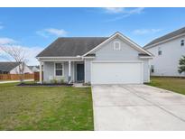 Charming single-story home features a well-maintained front yard and attached two-car garage at 420 Thoroughbred Dr, Moncks Corner, SC 29461