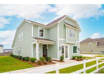 Charming two-story home with light green siding and a well-manicured lawn at 421 Grove End Rd, Moncks Corner, SC 29461