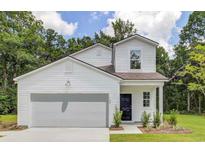Charming two-story home boasts a manicured lawn, attached garage and classic curb appeal at 506 Kitsap Ct, Summerville, SC 29486
