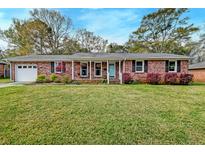 Charming brick ranch-style home with a well-manicured lawn and inviting curb appeal at 6019 Rembert Dr, Hanahan, SC 29410