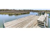 Waterfront home featuring a private wooden dock with deep water access, perfect for boating and enjoying the scenic views at 741 Creekside Dr, Mount Pleasant, SC 29464
