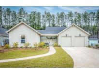 Charming single-story home with a well-manicured lawn and a two-car garage at 803 Smooth Stone Aly, Summerville, SC 29486