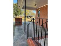 Inviting brick porch with black metal railing and supports, perfect for relaxing outdoors at 1236 Fort Dr, Hanahan, SC 29410