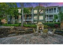 Charming outdoor fireplace and seating area, perfect for relaxing and entertaining al fresco, with building in background at 1325 Telfair Way, Charleston, SC 29412
