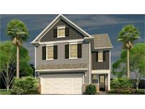 Charming two-story home with gray siding, a white garage door, and beautifully landscaped surroundings at 194 E Pinckney St, Lincolnville, SC 29485