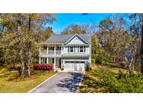 Charming two-story home featuring a welcoming front porch, a well-maintained lawn, and a private driveway at 2107 Nicholas David Path, Johns Island, SC 29455