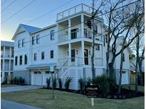 Stunning three-story coastal home with a rooftop deck and meticulous landscaping showcasing modern elegance at 2607 Cameron Blvd, Isle of Palms, SC 29451