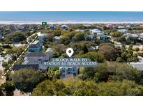 An aerial view shows a neighborhood of beach homes with a marked walking path to beach access, plus ocean views at 4006 Hartnett Blvd, Isle of Palms, SC 29451
