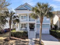 Charming two-story home with a porch, balcony, beautiful landscaping, and a two car garage at 4108 Whiting St, Mount Pleasant, SC 29466