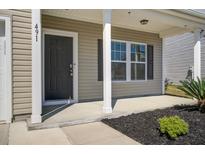 Charming home exterior featuring a covered porch, neutral siding, and landscaped front yard at 491 Fox Sparrow Ct, Summerville, SC 29486