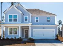 Charming two-story home with light blue siding, white trim, and an attached two-car garage at 509 Verdi Dr, Summerville, SC 29486