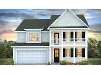 Charming two-story home with a covered porch and attached garage at 509 Yukon Ct, Lincolnville, SC 29485