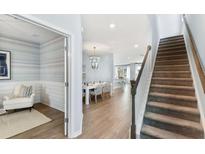 Inviting entryway with hardwood floors, a staircase, and an adjacent sitting room featuring stylish decor at 517 Verdi Dr, Summerville, SC 29486