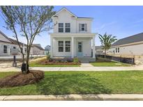 Charming two-story home with a quaint front porch and beautiful landscaping at 713 Rumbling Leaf Ln, Summerville, SC 29486