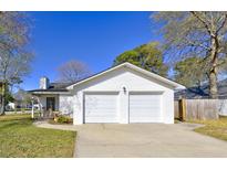 Charming home featuring an attached two-car garage and classic painted brick at 9861 Levenshall Dr, Ladson, SC 29456