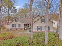 Charming home with well-maintained landscaping, inviting curb appeal, and traditional architectural details at 101 Plantation Dr, Summerville, SC 29485