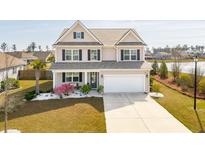 Charming two-story home boasts manicured landscaping, two-car garage, and inviting curb appeal at 109 Airy Dr, Summerville, SC 29486