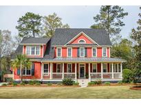 Inviting two-story home with a charming, expansive front porch and well-maintained landscaping at 1149 Lands End Dr, Hanahan, SC 29410