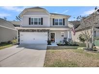 Charming two-story home with stone accents, a two-car garage, and a well-manicured front yard at 1173 Triple Crown Court, Mount Pleasant, SC 29429