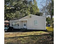 Charming single-story home with a cozy front porch and mature trees at 1255 Remount Rd, North Charleston, SC 29406