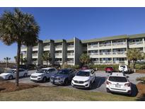 Multi-story condo building with balconies and well-maintained parking area and landscaping at 1300 Ocean Blvd # 139, Isle of Palms, SC 29451