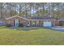 Charming single-story brick home featuring a covered front porch and a well-manicured lawn at 131 Kennington Dr, Goose Creek, SC 29445