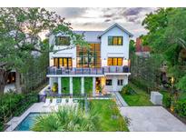 Stunning two-story modern farmhouse with a lush yard, pool, and a unique vertical garden at 204 E Huron Ave, Folly Beach, SC 29439