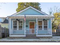 Charming home featuring light blue siding, a welcoming porch, and eye-catching architectural details at 2227 Mount Pleasant St, Charleston, SC 29403