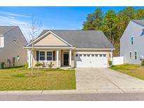 Charming single-story home with tan siding, black shutters, and an attached white single-car garage at 223 Sugarberry Lane, Moncks Corner, SC 29461