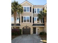 Charming townhome with a garage, front door, and a well-maintained landscaped yard at 2920 Woodland Park Dr, Mount Pleasant, SC 29466