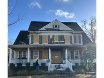 Two-story home with damaged roof and boarded windows at 3055 Yachtsman Dr, Mount Pleasant, SC 29466