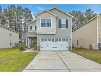 Charming two-story home featuring a two-car garage and well-maintained landscaping in a suburban setting at 343 Iveson Rd, Summerville, SC 29486