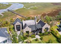 Stunning waterfront home with private dock and lush landscaping, boasting luxurious coastal living at 430 Fish Tale Rd, Charleston, SC 29492