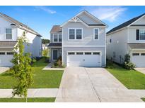 Charming two-story home featuring a well-manicured lawn, attached garage, and inviting curb appeal at 509 Purple Finch Rd, Summerville, SC 29486
