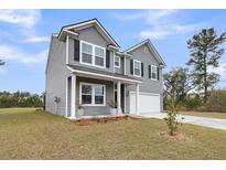 Charming two-story home featuring gray siding, black shutters and a two-car garage at 5115 Cranesbill Way, Johns Island, SC 29455