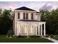 Charming two-story home featuring a welcoming front porch with classic columns and lush landscaping at 706 Rumbling Leaf Ln, Summerville, SC 29486
