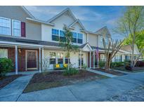Inviting townhouse exterior with a well-manicured lawn and charming curb appeal at 1002 Elm Hall Cir, Summerville, SC 29483