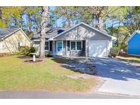 Charming single-story home with a well-maintained lawn and a welcoming front porch at 115 Tennyson Way, Summerville, SC 29486
